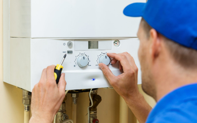 An engineer servicing a combi boiler